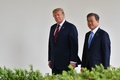 米首都ワシントンにあるホワイトハウスで韓国の文在寅大統領（右）と並んで歩くドナルド・トランプ米大統領（2019年4月11日撮影）。(c)Nicholas Kamm / AFP