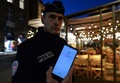 フランス北西部サンマロで、「衛生パス」確認のためのアプリを見せる警察官（2021年11月19日撮影）。(c)JEAN-FRANCOIS MONIER / AFP