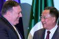 シンガポールでの東南アジア諸国連合（ASEAN）関連会合で、集合写真の撮影を前に言葉を交わすマイク・ポンペオ米国務長官（左）と北朝鮮の李容浩外相（2018年8月4日撮影）。(c)AFP PHOTO / MOHD RASFAN