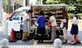 都内に駐車したトラックの移動式店舗で、パンを買う人たち（2013年8月30日撮影）。(c)AFP/Toru YAMANAKA