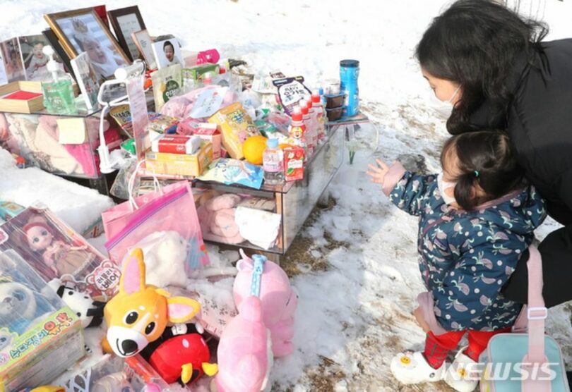 韓国京畿道楊平郡の公園墓地「アンデルセン・メモリアル・パーク」で、ジョンインちゃんの墓を訪ねる市民(c)NEWSIS