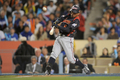 第2回ワールド・ベースボール・クラシック（%%2009 World Baseball Classic%%）決勝、韓国戦で8回に犠飛を放つ日本の岩村明憲（%%Akinori Iwamura%%）。（2009年3月23日撮影）(c)AFP/Getty Images/Kevork Djansezian