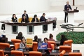 スウェーデンのNATO加盟承認法案の採決のため招集されたトルコ議会本会議で、反NATOのプラカードを掲げる議員（2024年1月23日撮影）。(c)Adem ALTAN / AFP