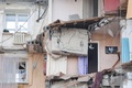 ロシア・マグニトゴルスクで、ガス爆発により崩壊した住居ビルの残骸（2019年1月2日撮影）。(c)AFP