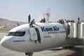 アフガニスタンの首都カブールの空港で、航空機の上に登って待機するアフガン人ら（2021年8月16日撮影）。(c)Wakil Kohsar / AFP