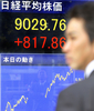 都内で、証券会社の株価ボードを眺める会社員の男性（2008年10月30日撮影）。(c)AFP/Toru YAMANAKA