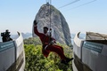 ブラジル・リオデジャネイロ（Rio de Janeiro）で、パン・デ・アスーカル山（Pao de Acucar）にあるロープエーのワイヤロープを滑車で滑り降りるサンタクロース姿の男性（2014年12月18日撮影）。(c)AFP/YASUYOSHI CHIBA