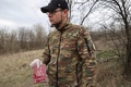 ウクライナ東部ハルキウ州シニハ村で、ロシア兵の遺体のそばで見つかったパスポートを見せるウクライナ兵（2023年4月8日撮影）。(c)Sergiy KOZLOV / AFP