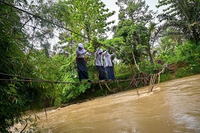 【今日の1枚】橋の修復ままならず、危険な渡河 インドネシア