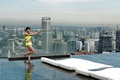 シンガポールの高級リゾートホテルのマリーナ・ベイ・サンズ（Marina Bay Sands）の屋上にある「インフィニティープール（Infinity Pool）」でくつろぐ女性（2014年5月20日撮影）。(c)AFP/ROSLAN RAHMAN