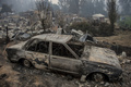 チリの山火事で壊滅的被害を受けたサンタ・オルガの町（2017年1月26日撮影）。(c)AFP/MARTIN BERNETTI
