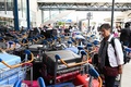 荷物仕分け機器が故障したフランス・オルリ空港で、カートに載せられた荷物を見る乗客（2023年8月3日撮影）。(c)STEFANO RELLANDINI / AFP