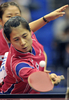09世界卓球選手権横浜大会（%%2009 World Table Tennis Championships in Yokohama%%）女子ダブルス準決勝。中国の郭炎（%%Guo Yan%%）／丁寧（%%Ding Ning%%）組は、韓国の金璟娥（%%Kim Kyung Ah%%）／朴美英（%%Park Mi Young%%）と対戦。郭炎／丁寧組は4-1（11-3、11-9、12-14、12-10、12-10）で勝利し、決勝戦へ進出した。写真はボールを打ち返す金璟娥。（2009年5月4日撮影）(c)AFP/Yoshikazu TSUNO