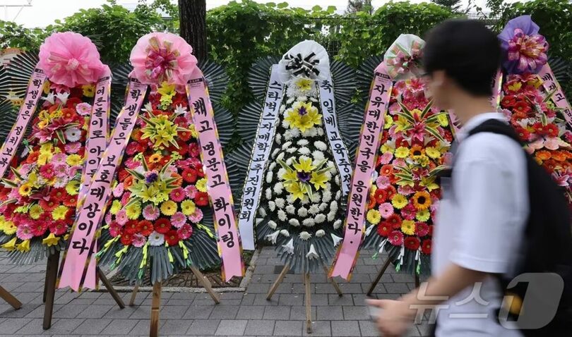 2日、ソウル・培材高校前に、培材高校野球部を批判する弔花輪と応援する花輪が置かれている(c)news1