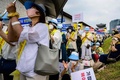 韓国・ソウルで抗議活動を行う世界平和統一家庭連合（旧統一教会）の信者ら（2022年8月18日撮影）。(c)Anthony WALLACE / AFP