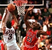 Chicago Bulls Michael Jordan (R) reacts as Philadelphia 76ers Allen Iverson goes up to the basket for two points in the game 15 January in Philadelphia, PA. (c)AFP/TOM MIHALEK 