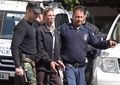 キプロス・ラルナカで、警察に付き添われ裁判所を出るセイフ・アルディン・モハメド・ムスタファ容疑者（2016年3月30日撮影）。(c)AFP/GEORGE MICHAEL
