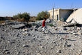 シリア北部ラッカ西部地域で、建物のがれきの中を歩く避難民の少年（2017年8月14日撮影）。(c)AFP/DELIL SOULEIMAN