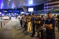 自爆攻撃に見舞われたトルコ・イスタンブールのアタチュルク国際空港の玄関口前に立つ人々（2016年6月28日撮影）。(c)AFP/OZAN KOSE