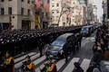 ウィルバート・モラ巡査のひつぎをのせた霊きゅう車を沿道で見つめる警察官。米ニューヨークで（2022年2月2日撮影）。(c)Ed JONES / AFP