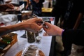 タイ中部ナコンパトム県で開催された大麻の合法化を祝うイベント「タイランド420: リーガルレーオ⁉」で、大麻を買う人（2022年6月11日撮影）。(c)Lillian SUWANRUMPHA / AFP