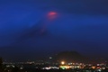 雲に覆われたマヨン山から噴出した赤い溶岩。フィリピン・マニラの南東にあるアルバイ州レガスピから撮影（2018年1月15日撮影）。(c)AFP PHOTO / Simvale SAYAT
