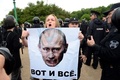 ロシアのサンクトペテルブルクで行われた反政府デモで、ウラジーミル・プーチン大統領の写真を掲げる参加者（2017年6月12日撮影）。(c)AFP/OLGA MALTSEVA