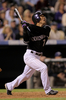 6回に犠牲フライを放つロッキーズの松井稼頭央。(c)AFP/Getty Images Doug Pensinger