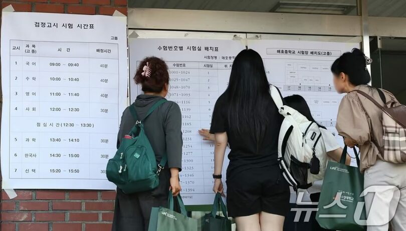大邱市寿城区の梅湖中学校で、2024年度第2回学力認定試験の試験室配置表を確認する受験生(c)news1