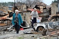 ウクライナ首都キーウ北西にある集落モシチュンで、破壊された自宅跡を歩く住民（2022年4月20日撮影）。(c)Genya SAVILOV / AFP