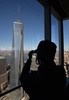 米ニューヨーク（New York）で、世界貿易センター（World Trade Center）の跡地に完成した高層ビル「フォー・ワールド・トレード・センター（Four World Trade Center、4WTC）」の68階から建設中の高層ビル「ワン・ワールド・トレード・センター（One World Trade Center）」の写真を撮る男性（2013年11月13日撮影）。(c)AFP/Stan HONDA