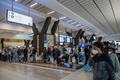 南アフリカ・ヨハネスブルクのO・R・タンボ国際空港で、搭乗手続きに並ぶ乗客（2021年11月27日撮影）。(c)Phill Magakoe / AFP