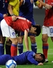 サッカー国際親善試合、韓国対日本。韓国の李青龍（Lee Chung-Yong、イ・チョンヨン）と衝突し、ピッチに倒れる日本の駒野友一（Yuichi Komano、下）。（2010年10月12日撮影）(c)AFP/JUNG YEON-JE