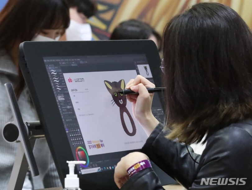 韓国のウェブトゥーンフェアで作品を描く参加者(c)NEWSIS