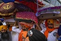 インドの首都にあるデリー国際空港で、アフガニスタンから退避してきたシーク教徒が持ち帰った同教の聖典「グル・グラント・サーヒブ」を運ぶ男性（2021年8月24日撮影）。(c)Money SHARMA / AFP