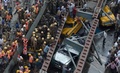 インド・コルカタで、高架道路が崩落した現場で救出活動に当たる救助隊員ら（2016年3月31日撮影）。(c)AFP/Dibyangshu SARKAR