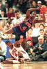 Detroit Pistons guard Joe Dumars (4) tries to pass over fallen Chicago Bulls forward Dickey Simpkins (8) 13 December 1994 during the first quarter at the United Center in Chicago, Illinois. (c)AFP/EUGENE GARCIA