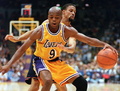 Guard Nick Van Exel (9) of the Los Angeles Lakers avoids the steal attempt by Mahmoud Abdul-Rauf of the Denver Nuggets in first half action of their 03 November NBA game in Inglewood, California. The Lakers won their season opener, 98-96, despite having 29 turnovers. (c)AFP/Vince BUCCI