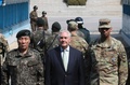 南北軍事境界線上の板門店を訪問し、在韓米軍のビンセント・ブルックス司令官（右）と並ぶレックス・ティラーソン米国務長官（中央）、およびその背後で韓国側をのぞき込む北朝鮮の兵士たち（2017年3月17日撮影）。(c)AFP/Lee Jin-man