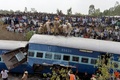 インド・バンガロールから約40キロ離れたアネカル近くで起きた列車の脱線事故の現場で、遺体を搬送する消防隊員と集まった群衆（2015年2月13日撮影）。(c)AFP/Manjunath KIRAN