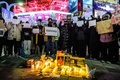 韓国ソウルで、中国で行われているデモを支持する集会を開く人々（2022年11月30日撮影）。(c)Anthony WALLACE / AFP