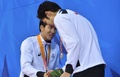 第17回アジア競技大会（17th Asian Games、Asiad）競泳男子200メートル個人メドレー決勝。表彰台で藤森太将（Hiromasa Fujimori、左）と握手する萩野公介（Kosuke Hagino、2014年9月22日撮影）。(c)AFP/PHILIPPE LOPEZ