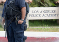米カリフォルニア（California）州ロサンゼルス（Los Angeles）で、クリストファー・ドーナー（Christopher Dorner）容疑者の警察に対する襲撃予告をうけ、ロサンゼルス市警察学校前で警備に立つ警察官（2013年2月7日撮影）。(c)AFP/JOE KLAMAR