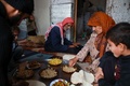 シリア北西部イドリブ県の町ハーレムにある避難民キャンプで、キノコ料理を食べる一家（2019年11月29日撮影）。(c)Aaref WATAD / AFP