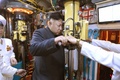 北朝鮮国内で朝鮮人民軍海軍第167軍部隊の潜水艦第748号を視察し、汗をかきながら潜望鏡をのぞき込む金正恩（キム・ジョンウン、Kim Jong-Un）第1書記。北朝鮮の朝鮮中央通信（Korean Central News Agency、KCNA）配信（撮影日不明、2014年6月16日配信）。(c)AFP/KCNA via KNS