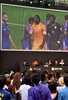 都内で行われた家庭用ゲーム機「プレイステーション4（PlayStation 4、PS4）」用サッカーゲーム「FIFA 14  2014 FIFA World Cup Brazil  Limited Pack」の発売イベントで、大型スクリーンに映ったゲーム画面を眺めるサッカーファンら（2014年6月4日撮影）。(c)AFP/Yoshikazu TSUNO