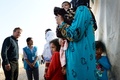 レバノン東部ベカー高原にあるシリア難民キャンプで、難民の家族が住むテントを訪れた英国のデービッド・キャメロン首相（左、2015年9月14日撮影）。(c)AFP/STEFAN ROUSSEAU