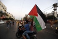 パレスチナ自治区ガザ地区（Gaza Strip）ガザ市（Gaza City）で、イスラエルとパレスチナが合意に至った長期停戦を祝うパレスチナ住民ら（2014年8月26日撮影）。(c)AFP/MOHAMMED ABED