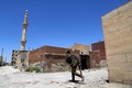 シリア民主軍（SDF）がイスラム過激派組織「イスラム国（IS）」奪還した北部ラッカ西郊のダリヤの通りを横断するSDFの戦闘員（2017年6月27日撮影）。(c)AFP/DELIL SOULEIMAN