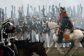 フランス皇帝ナポレオン（Napoleon）の遠征軍と帝政ロシア軍が激戦を繰り広げた1812年の「ボロジノの戦い」から今年で200年となることを記念し、モスクワ（Moscow）西方のボロジノ（Borodino）で2日、戦いを再現するイベントが行われた。

　当時の軍服や刀剣などを用いて戦いを忠実に再現したイベントには、ロシア政府が110万ドル（約8700万円）を出資。フランス側1550人、ロシア側1450人の兵士を演じる計3000人が参加。ジスカール・デスタン（Giscard d&apos;Estaing）仏元大統領と、ウラジーミル・プーチン（Vladimir Putin）露大統領も「観戦」に訪れた。これに先立ち、プーチン大統領の補佐官は「ボロジノの戦い」再現イベントを「若者の愛国教育」を広めるために活用したいと述べた。

　1812年9月7日の「ボロジノの戦い」は合戦では勝利しながら、戦争には負けた戦将の際立った例だ。

　ボロジノでは2万人のナポレオン軍が激戦の末に、兵力の多い4万5000人の露軍を破った。しかし痛手が大きかったため、ナポレオンはモスクワに進軍を開始する前に回復期間を置くことにした。この時にナポレオンはおそらく、敵方のクトゥーゾフ将軍が戦闘の翌日に一時撤退したことを知らなかったとされる。この休息の決断が、ナポレオンにとって致命的な誤算だった。

　帝政ロシア軍は兵力の半分を失っていたが、近くの村落で体制を立て直す時間ができ、戦術を練った。ナポレオン軍が入城したモスクワは、市民は脱出しもぬけの殻で、そこに焦土戦術が追い打ちをかけた。士気を失ったナポレオン軍は退却を余儀なくされた（2012年9月2日撮影）。(c)AFP/Kirill Kudryavtsev